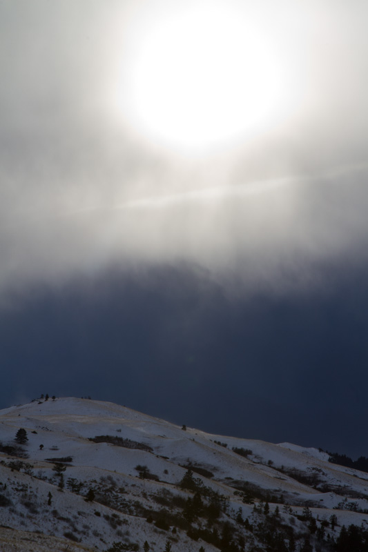 Sun Above Snow Covered Hillside