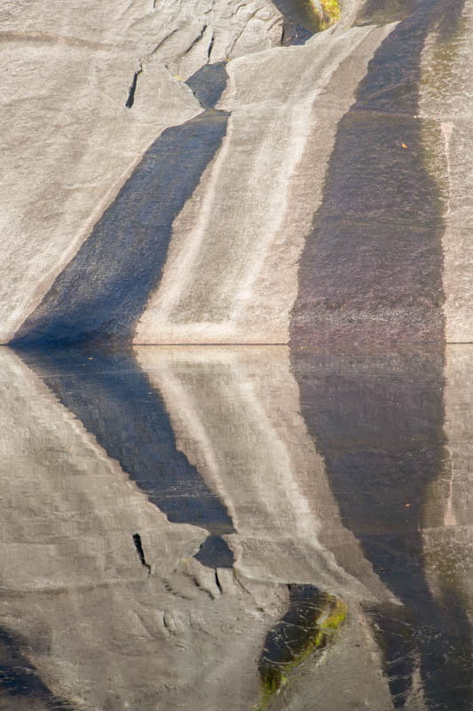 Rock Face Reflected In Pool