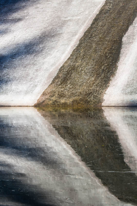 Rock Face Reflected In Pool